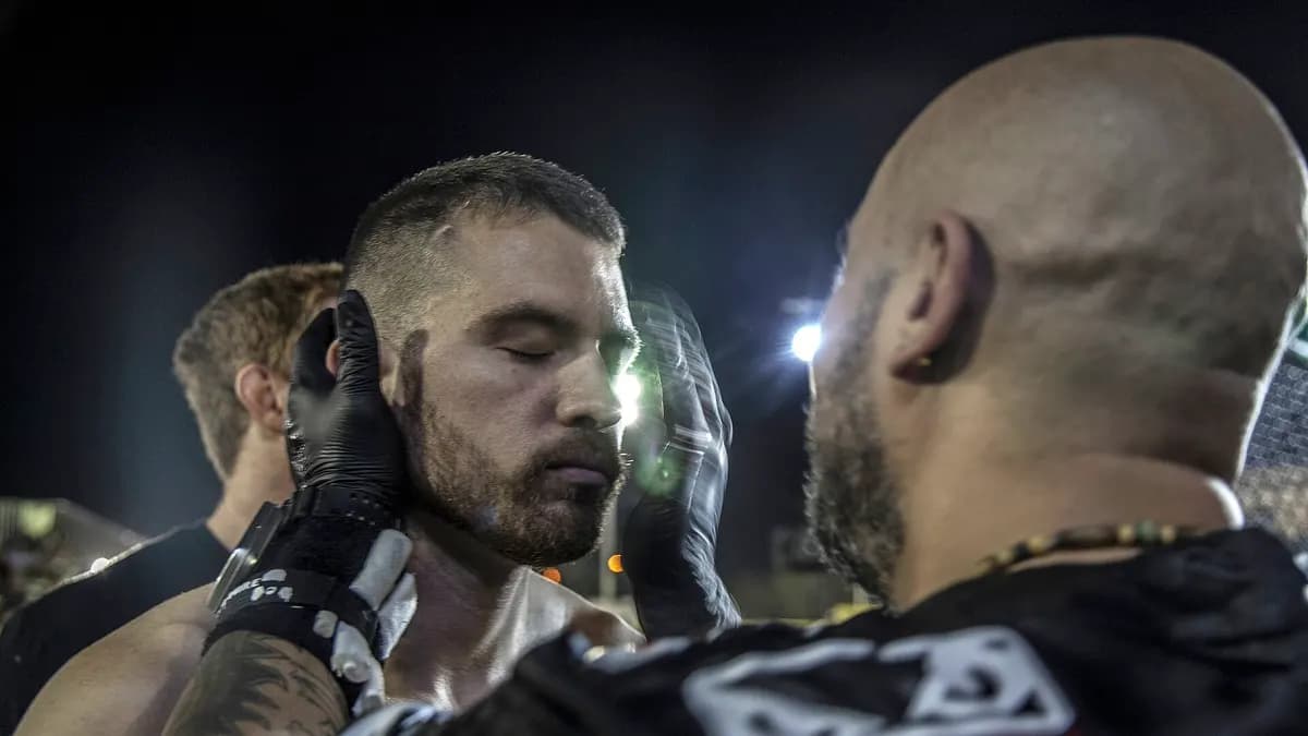 An empty UFC octagon lit up inside an arena ahead of a fight night